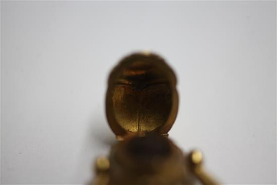 An early 20th century 14k gold swivelling Scarab locket ring, size N.